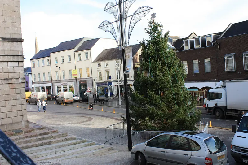 A Christmas tree beside the steps of Market Street in Armagh, with Georgian shopfronts along the street behind